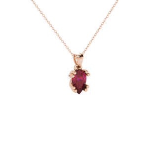 Close-up, pear shape raspberry red gemstone pendant, rose gold vintage basket.