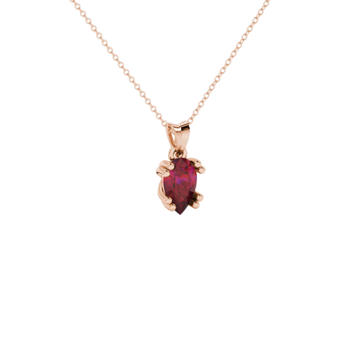 Close-up, pear shape raspberry red gemstone pendant, rose gold vintage basket.