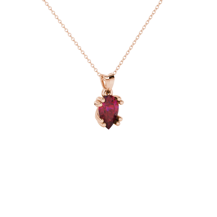 Close-up, pear shape raspberry red gemstone pendant, rose gold vintage basket.