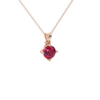 close-up shot of a round raspberry red gemstone pendant with a rose gold four-prong design.