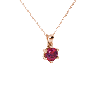 close-up shot of a round raspberry red gemstone pendant with a rose gold six-prong design.