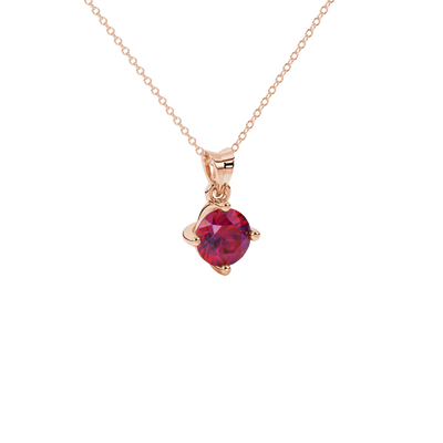 close-up shot of a round raspberry red gemstone pendant with a rose gold classic basket design.