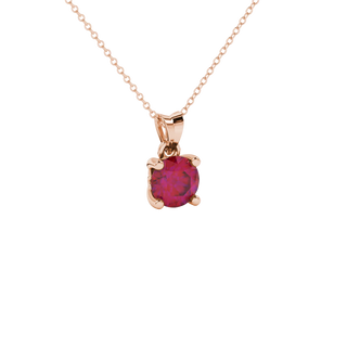Close-up shot of a round raspberry red gemstone pendant with a rose gold lotus basket design.