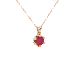 close-up shot of a round raspberry red gemstone pendant with a rose gold scalloped six-prong design.