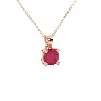 close-up shot of a round raspberry red gemstone pendant with a rose gold surprise diamond setting design.