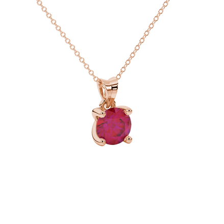 close-up shot of a round raspberry red gemstone pendant with a rose gold surprise diamond setting design.