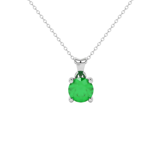 Round-cut emerald green gemstone pendant in a white gold surprise diamond setting.