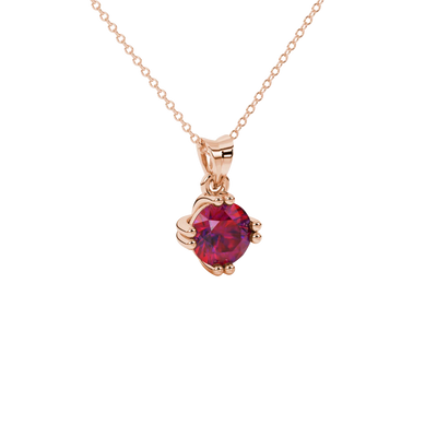 close-up shot of a round raspberry red gemstone pendant with a rose gold vintage basket design.