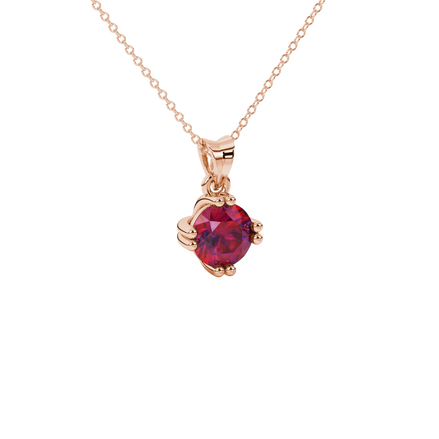 close-up shot of a round raspberry red gemstone pendant with a rose gold vintage basket design.