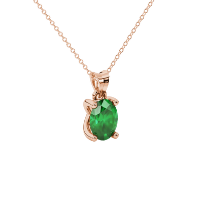 Close-up, oval cut emerald green gemstone pendant, rose gold four prong setting.