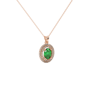 Close-up, oval cut emerald green gemstone pendant, rose gold double halo.