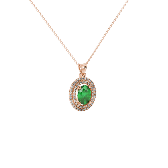 Close-up, oval cut emerald green gemstone pendant, rose gold double halo.