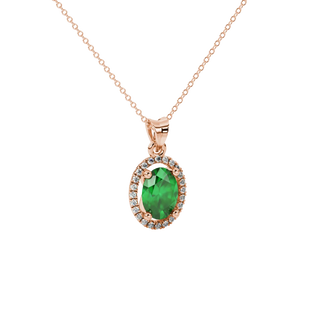 Close-up, oval cut emerald green gemstone pendant, rose gold french pavé halo.