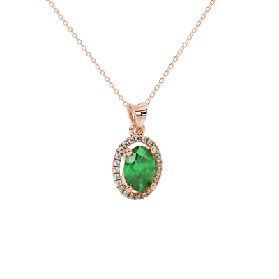Close-up, oval cut emerald green gemstone pendant, rose gold french pavé halo.