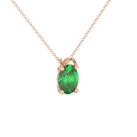 Close-up, oval cut emerald green gemstone pendant, rose gold pavé basket.