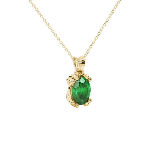 Close-up, oval cut emerald green gemstone, yellow gold vintage basket pendant.