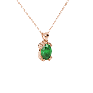 Close-up, oval cut emerald green gemstone pendant, rose gold vintage basket.