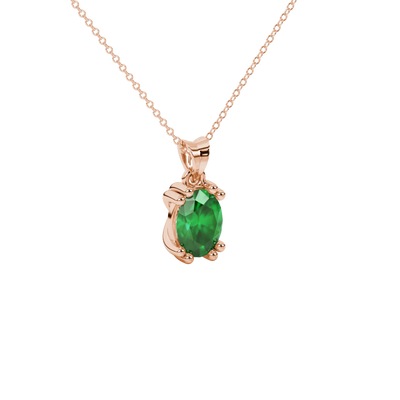 Close-up, oval cut emerald green gemstone pendant, rose gold vintage basket.