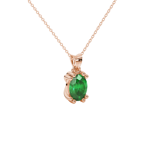 Close-up, oval cut emerald green gemstone pendant, rose gold vintage basket.