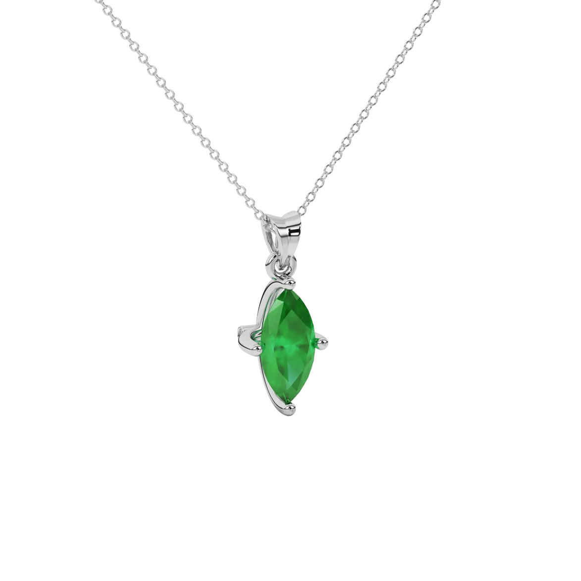Close-up marquise cut emerald green gemstone, white gold surprise diamond setting.