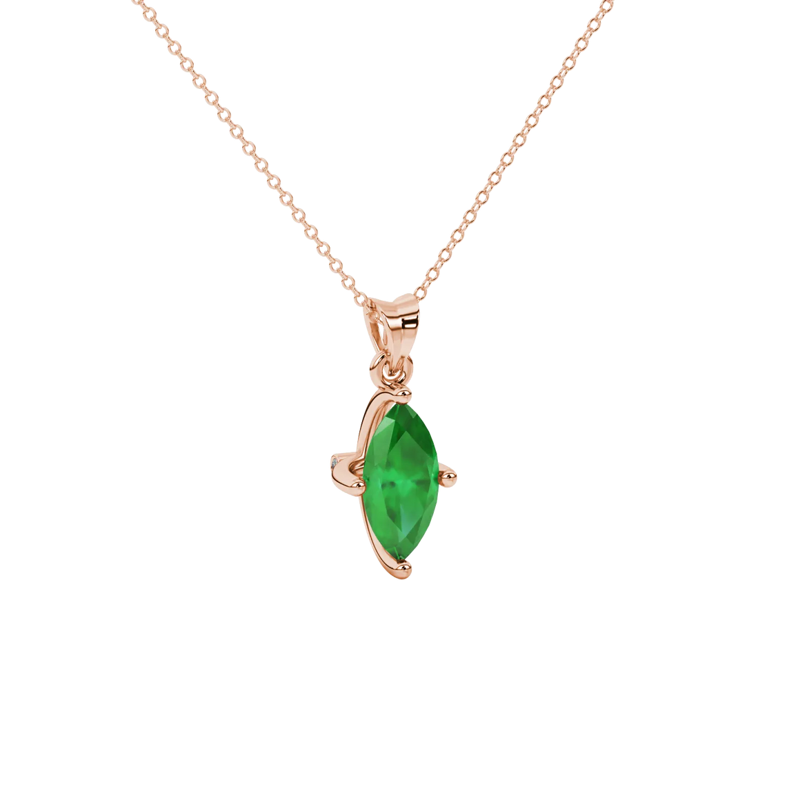 Close-up, marquise cut emerald green gemstone pendant, rose gold surprise diamond setting.