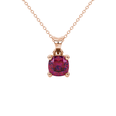 Red cushion cut gemstone solitaire pendant in gold featuring a refined four-prong basket setting