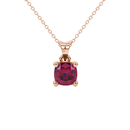 Red cushion cut gemstone solitaire pendant in gold featuring a refined four-prong basket setting