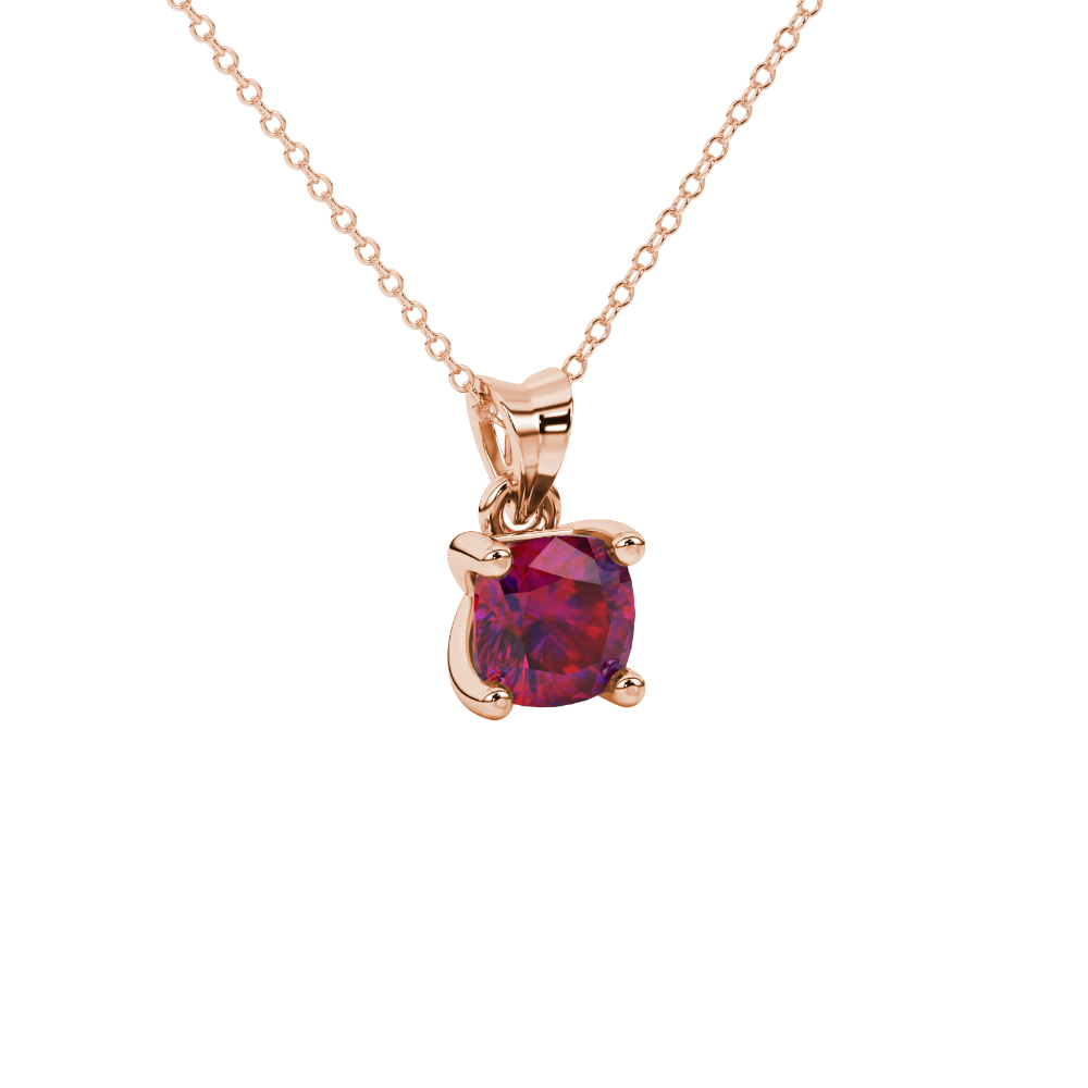 Red cushion cut gemstone solitaire pendant in gold featuring a refined four-prong basket setting