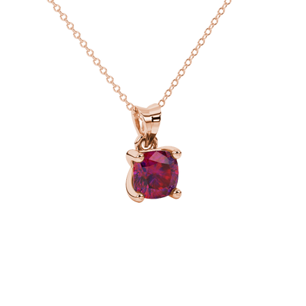 Red cushion cut gemstone solitaire pendant in gold featuring a refined four-prong basket setting