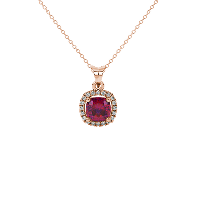 Red cushion cut gemstone halo pendant with diamond accents in gold
