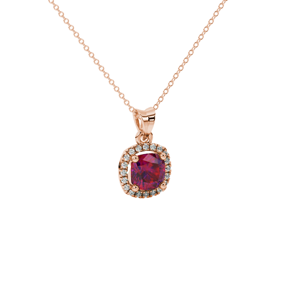 Red cushion cut gemstone halo pendant with diamond accents in gold