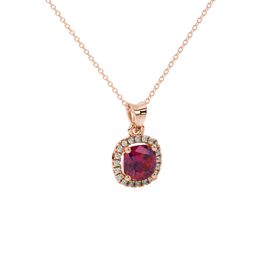 Red cushion cut gemstone halo pendant with diamond accents in gold