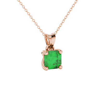 close-up shot of a radiant emerald green gemstone pendant with a classic rose gold four-prong setting.