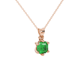 close-up shot of a radiant emerald green gemstone pendant with a classic rose gold six-prong setting.