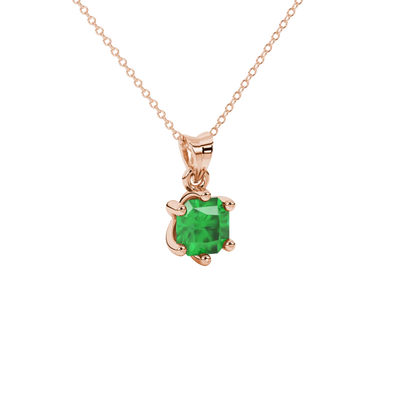 close-up shot of a radiant emerald green gemstone pendant with a classic rose gold six-prong setting.