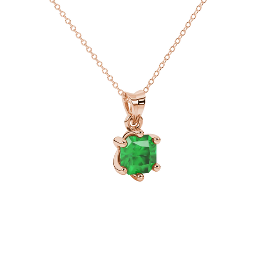 close-up shot of a radiant emerald green gemstone pendant with a classic rose gold six-prong setting.