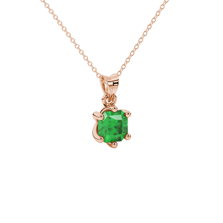 close-up shot of a radiant emerald green gemstone pendant with a classic rose gold six-prong setting.