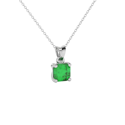 Close-up details of a radiant emerald green gemstone secured in a white gold classic basket pendant.