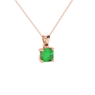 close-up shot of a radiant emerald green gemstone pendant with a rose gold classic basket gallery.
