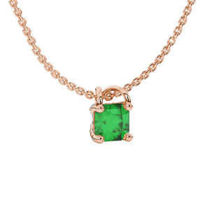 close-up shot of a radiant emerald green gemstone pendant with a rose gold pavé basket gallery.