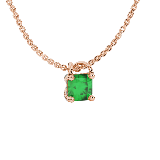 close-up shot of a radiant emerald green gemstone pendant with a rose gold pavé basket gallery.