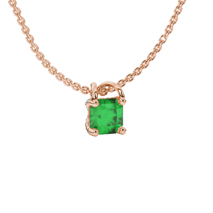close-up shot of a radiant emerald green gemstone pendant with a rose gold pavé basket gallery.