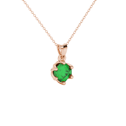 close-up shot of a radiant emerald green gemstone pendant with a rose gold scalloped six-prong design.