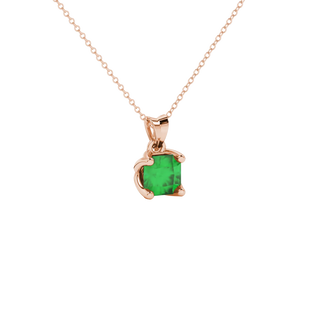 close-up shot of a radiant emerald green gemstone pendant with a rose gold tulip basket gallery.