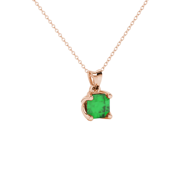 close-up shot of a radiant emerald green gemstone pendant with a rose gold tulip basket gallery.