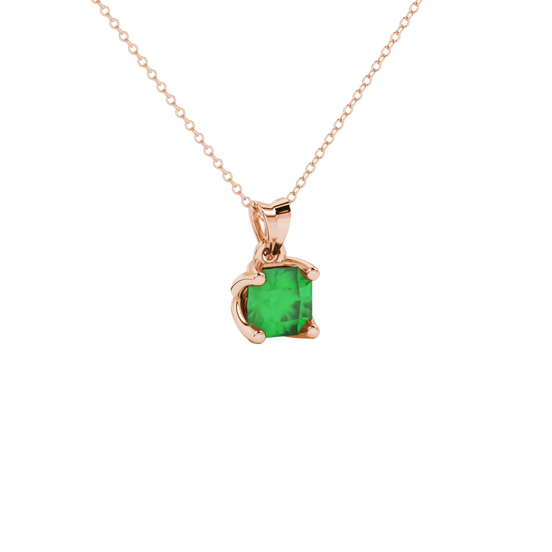 close-up shot of a radiant emerald green gemstone pendant with a rose gold tulip basket gallery.