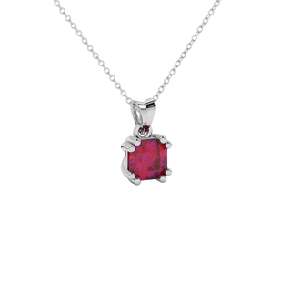 close-up of a radiant raspberry red gemstone enclosed in a white gold vintage basket pendant setting.