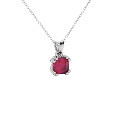 close-up of a radiant raspberry red gemstone enclosed in a white gold vintage basket pendant setting.