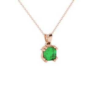 close-up shot of a radiant emerald green gemstone pendant with a rose gold vintage basket gallery.