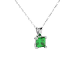 Close-up emerald green gemstone pendant, white gold four-prong setting.